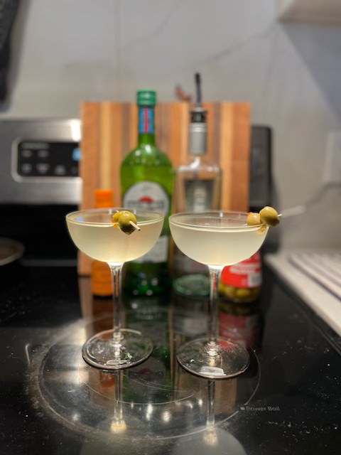 Dirty Martinis garnished with two scewered olives